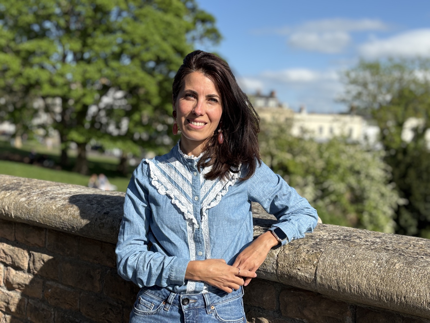 Natacha, founder of The Beauty of Caring, smiling outdoors in Bristol
